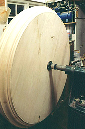 Photograph of a very large turned piece, mounted in a lathe